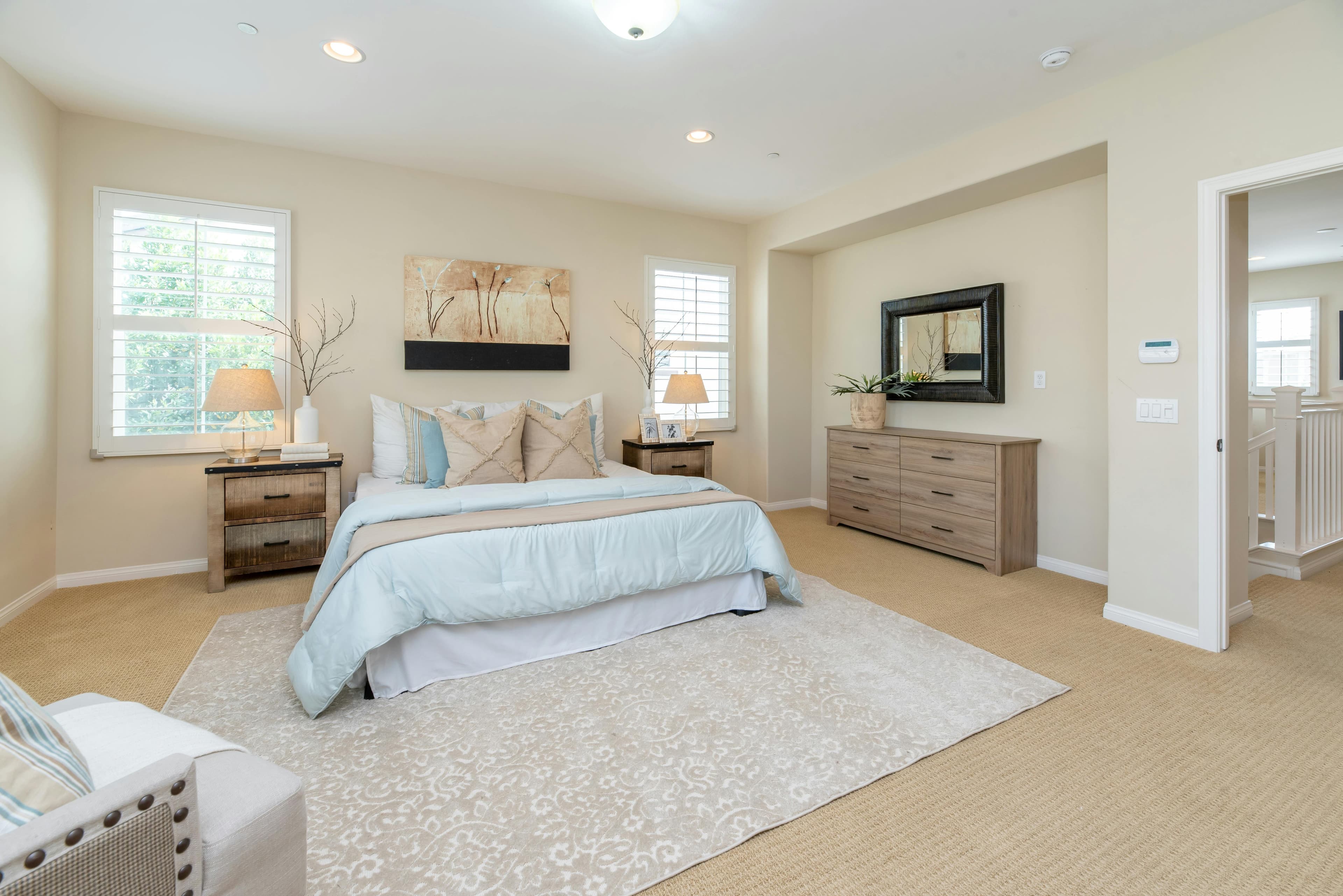 Bedroom with warm lighting and wooden headboard.