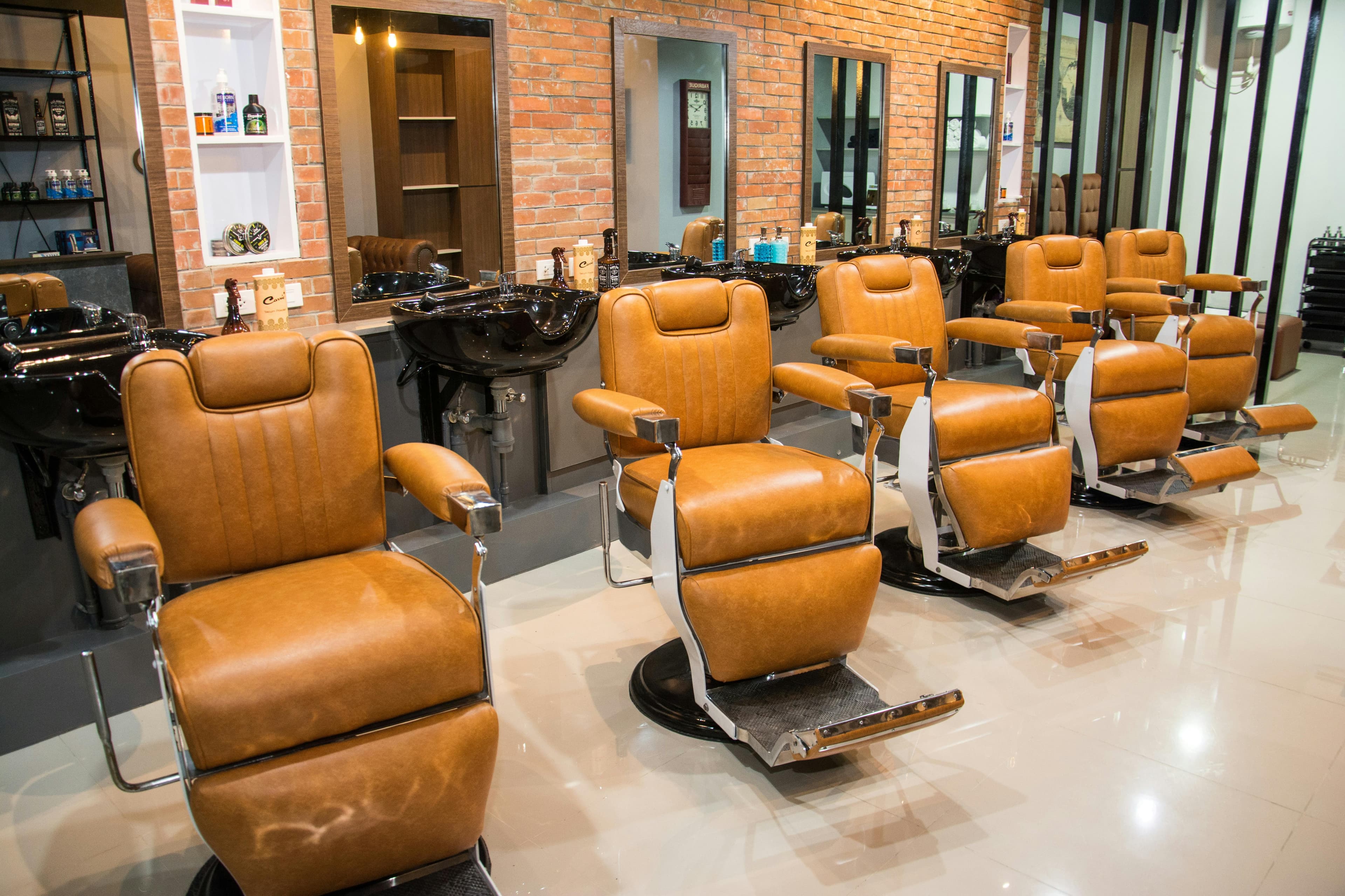Hair styling area with leather chairs.